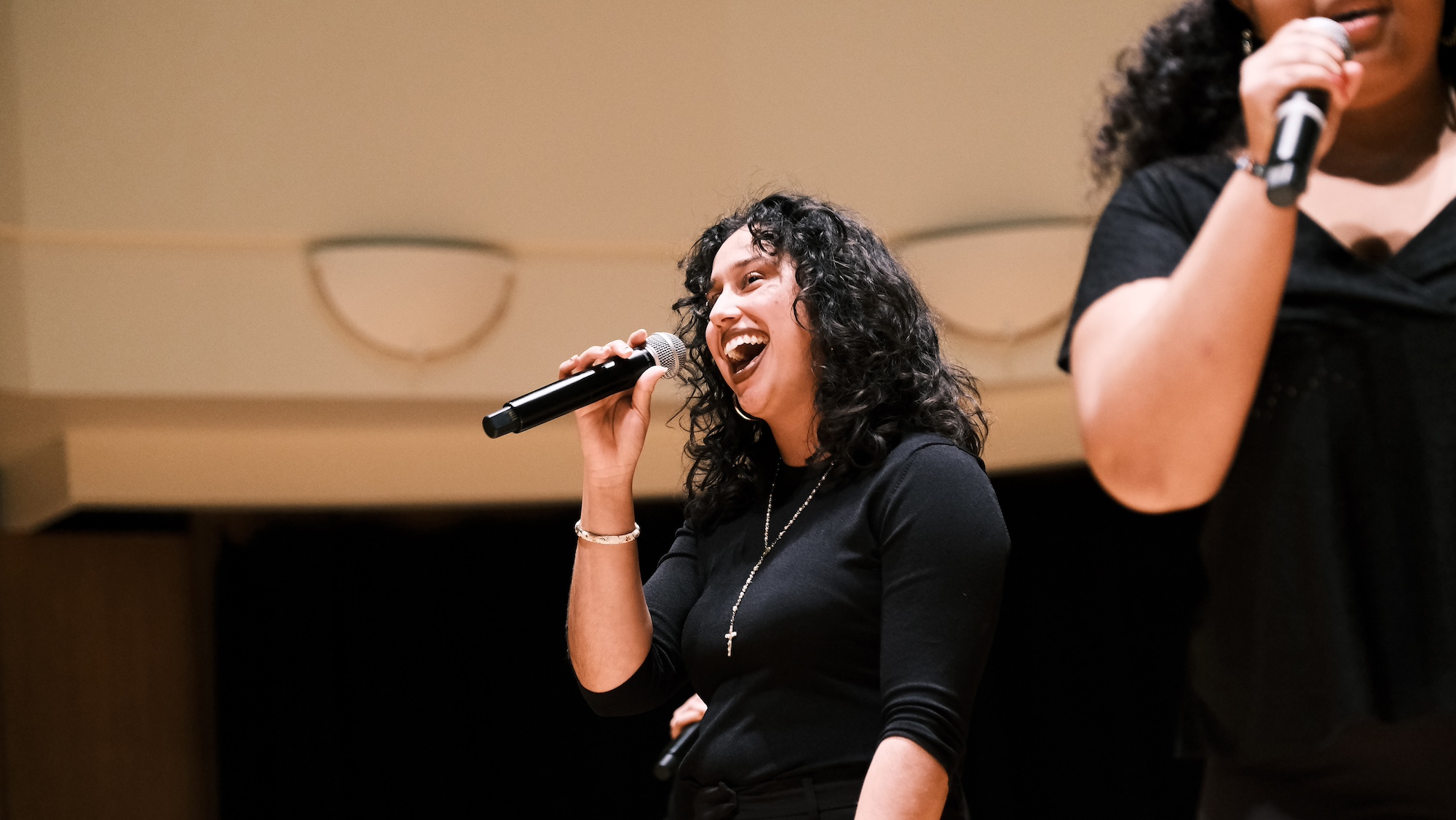 Young person singing into a mic