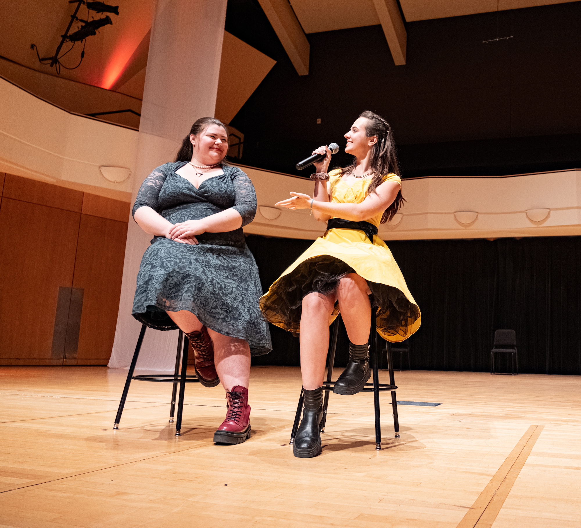 Two students speaking at the Alumni A Cappella concert