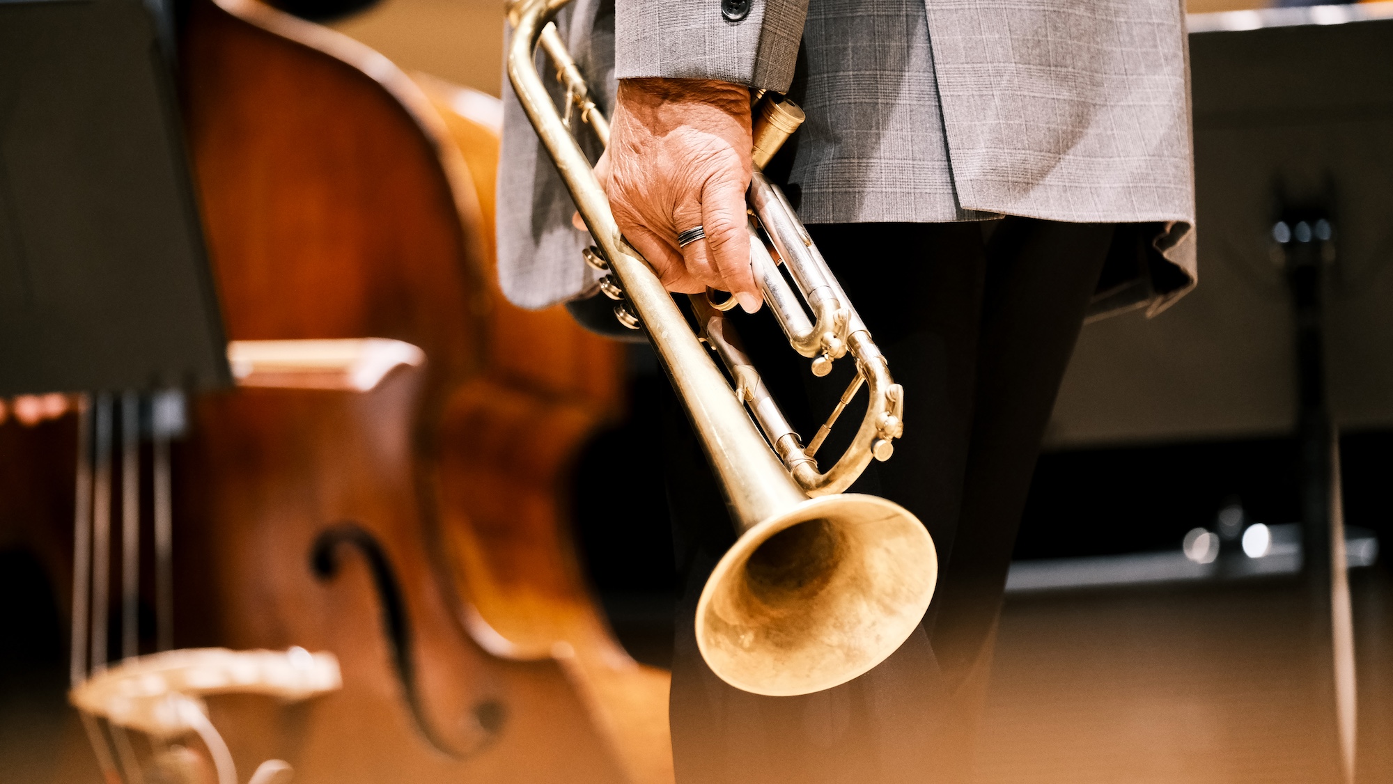 Eddie Henderson holds his trumpet onstage.