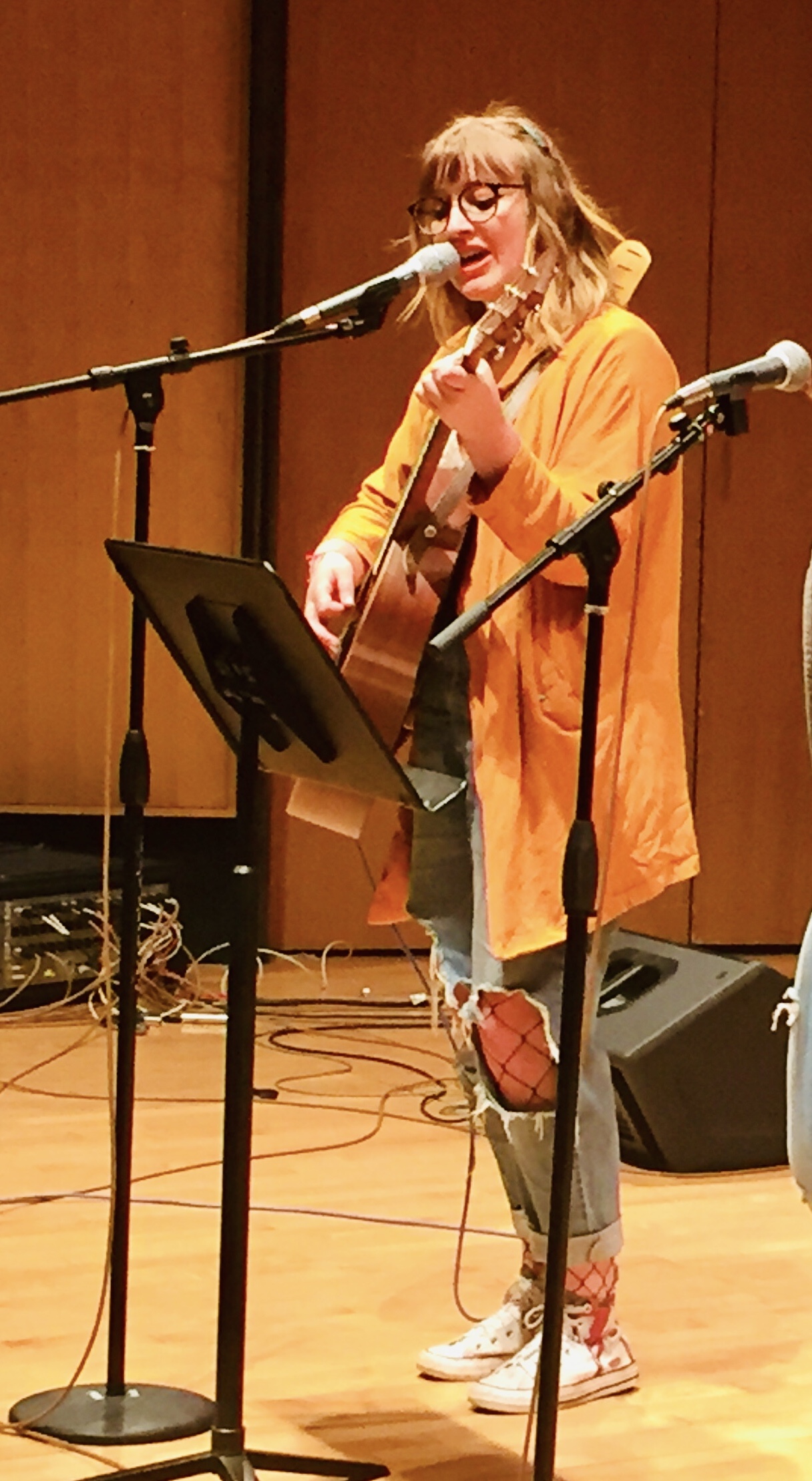 young woman playing guitar and singing