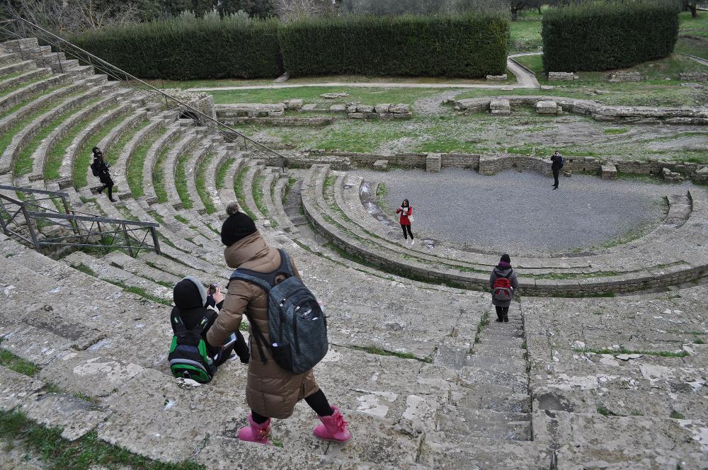 Students walking along steps of ruins in Italy