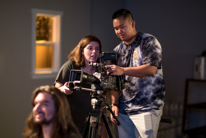 Two students operating a camera