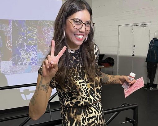 women in front of prints