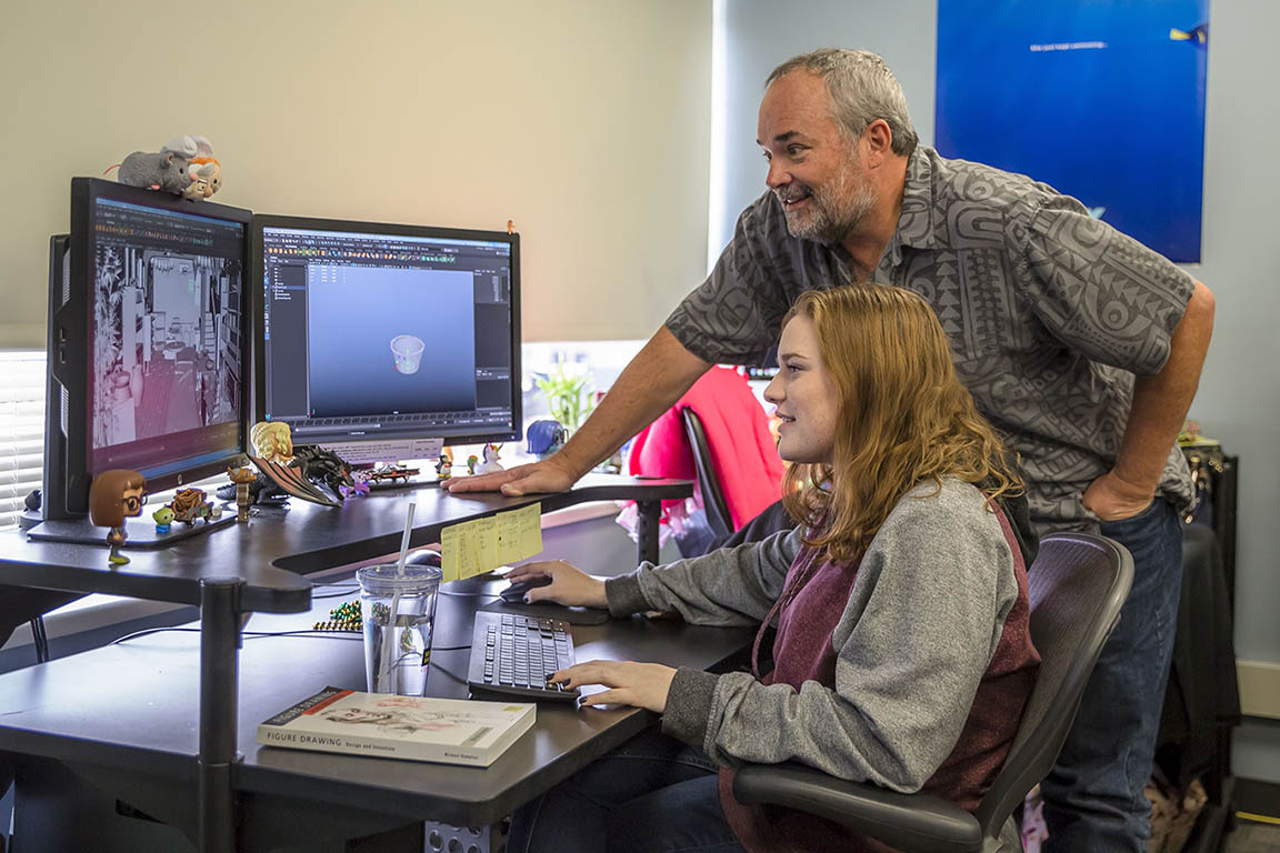 Howard Cook helping student in animation